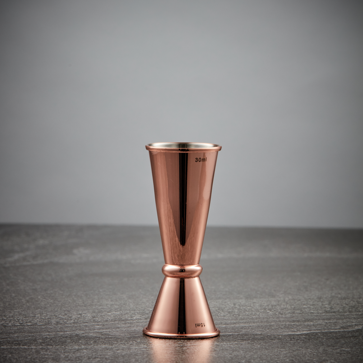 copper-finished japanese jigger with measurements inside-cocktail